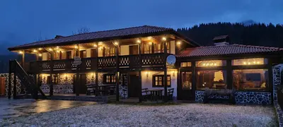 a large house with lights on it at night at Къща за гости Имало едно време in Smolyan