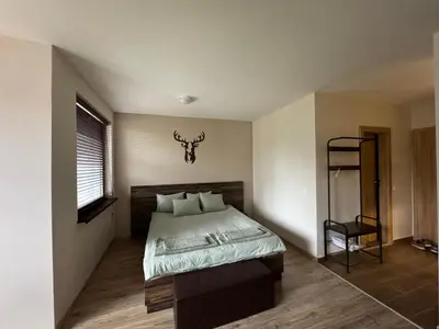 a bedroom with a large bed and a window at Borovets Gardens Chill Hill Studio by Joro in Borovets