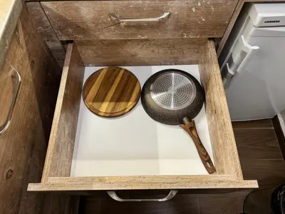 a wooden drawer with a frying pan and a whisk at Borovets Gardens Chill Hill Studio by Joro in Borovets