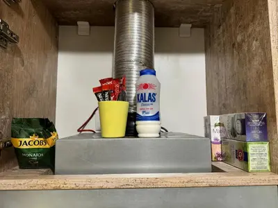 a shelf with a bottle of milk and a drink at Borovets Gardens Chill Hill Studio by Joro in Borovets
