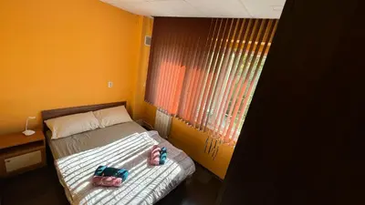 a small bedroom with a bed with two stuffed animals on it at Astoriq in Sofia