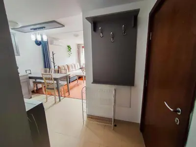 a room with a door and a kitchen and a dining room at Deluxe Apartment In Belvedere With Terrace in Bansko