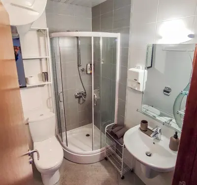 a bathroom with a shower and a toilet and a sink at Deluxe Apartment In Belvedere With Terrace in Bansko