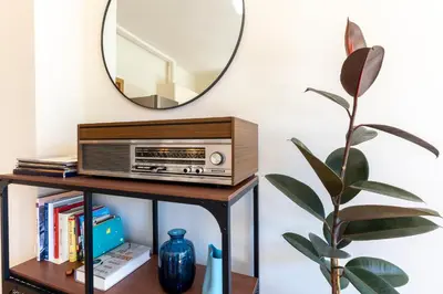 a mirror and a radio on a table with a plant at The Architect Home - City Center, Free Parking! in Sofia