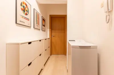 a white laundry room with a washer and dryer at The Architect Home - City Center, Free Parking! in Sofia