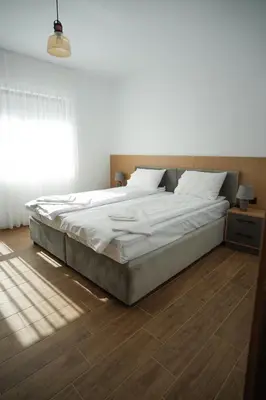 a large bed in a bedroom with a window at Sun City Apartment in Sandanski