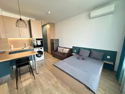 a small apartment with a bed and a kitchen at Noble House Comfort Place in Sofia