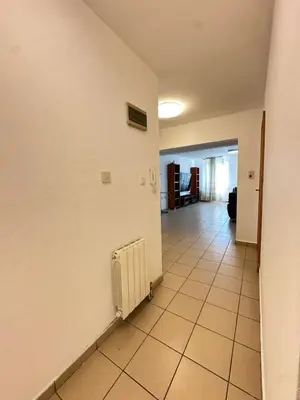 a hallway with a white wall and a radiator at Central District 3 Bedroom Place in Plovdiv