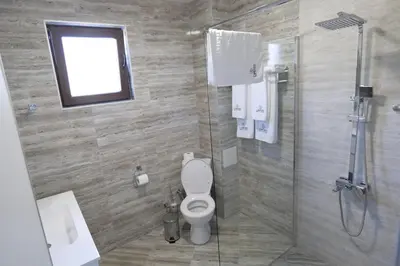 a bathroom with a toilet and a shower at Самуил къща за гости in Ognyanovo