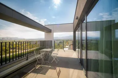 a balcony of a house with a table and chairs at My Campus 1 bdrm, Mountain view, Free parking, Self check-in in Sofia