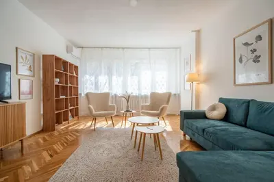a living room with a couch and chairs and a table at Modern and Calm 2BDRM Apt in City Centre in Sofia