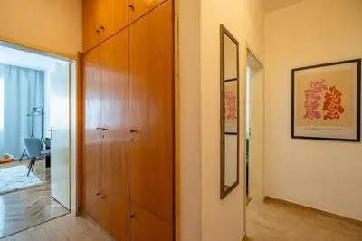 a hallway with a wooden cabinet and a mirror at Modern and Calm 2BDRM Apt in City Centre in Sofia