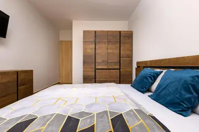 a bedroom with a large bed with blue pillows at Bright and Cozy Apartment Next to a City Park by Flat Mаnager in Plovdiv