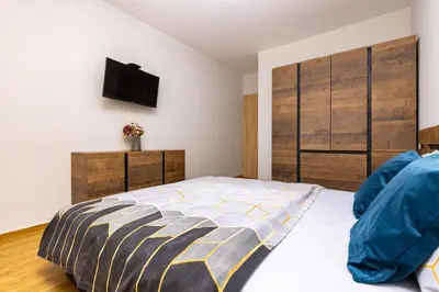 a bedroom with a bed and a tv on the wall at Bright and Cozy Apartment Next to a City Park by Flat Mаnager in Plovdiv