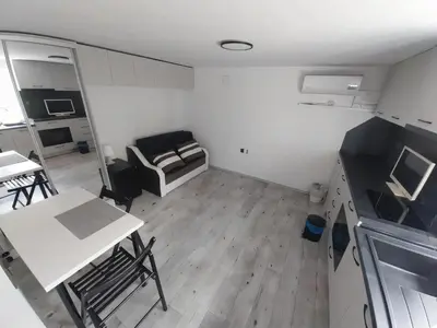 a small room with a kitchen and a table and chairs at Independent studio in a house in the city in Sofia
