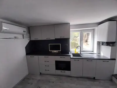 a kitchen with white cabinets and a sink and a window at Independent studio in a house in the city in Sofia