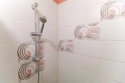 a shower with a shower head in a bathroom at 1-bedroom City Center secret gem in Plovdiv