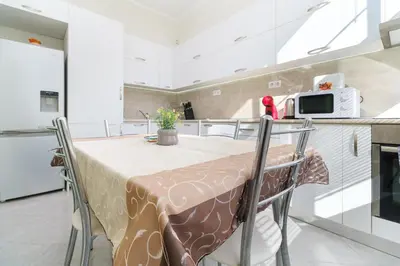 a kitchen with a table with chairs and a microwave at 1-bedroom City Center secret gem in Plovdiv