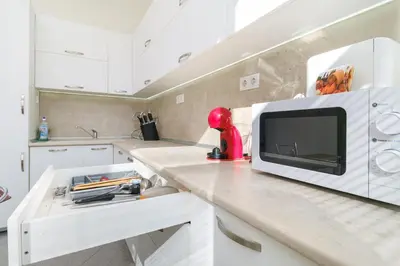 a kitchen with a counter with a microwave on it at 1-bedroom City Center secret gem in Plovdiv