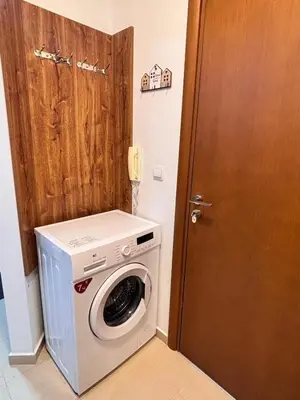 a washer and dryer in a room with a door at Belvedere Holiday Club H80 in Bansko