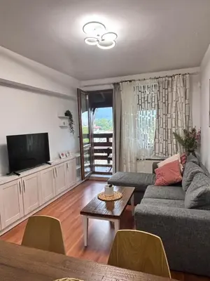 a living room with a couch and a tv at Belvedere Holiday Club H80 in Bansko