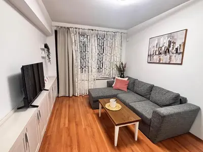 a living room with a gray couch and a table at Belvedere Holiday Club H80 in Bansko