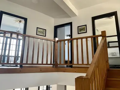 a staircase in a house with two windows at Large Cosy House by a Forest - Treehouse, BBQ, Fireplace & Mountain in Sopot