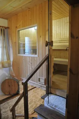 a small room with a staircase in a wooden cabin at Valkanovi House in Pamporovo