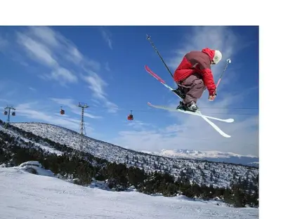 a man flying through the air while riding skis at Ski liviomoritz at gma il com Chalet in Madzhare
