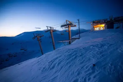 a ski lift on a snow covered slope at night at Ski liviomoritz at gma il com Chalet in Madzhare