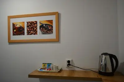a table with a coffee maker and a picture on the wall at TOP Center, basement fl, 7 beds, 10min from Serdica in Sofia