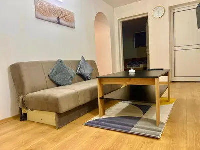 a living room with a couch and a table at TOP Center, basement fl, 7 beds, 10min from Serdica in Sofia