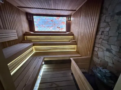 a sauna with a window and stairs in it at Мия4 Спа хотел Свети Спас in Velingrad