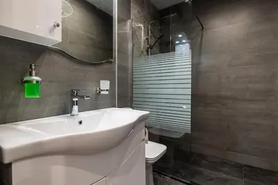 a bathroom with a white sink and a toilet at The Secret Paradise in Sofia