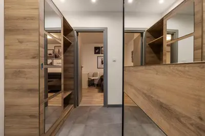 a pivot door in a hallway with wood paneling at The Secret Paradise in Sofia
