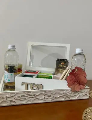 a wooden table with a tea box and two bottles at Апартамент Пирин in Sandanski