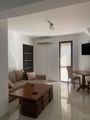 a living room with a couch and a table at Апартамент Пирин in Sandanski