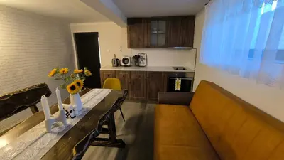a living room with a couch and a table at Къща за гости Етерна - Guest house Eterna in Starosel