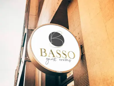 a sign for a restaurant on the side of a building at BASSO Guest Rooms in Perushtitsa