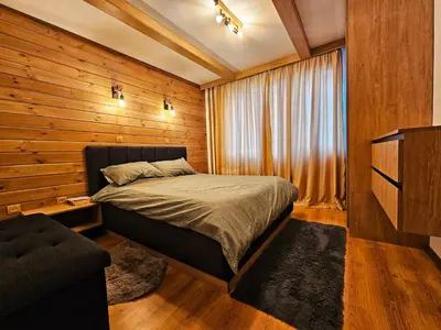 a bedroom with a bed and a television in it at Ski In Out Aparthotel Kosara in Bansko