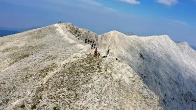 a group of people standing on the side of a mountain at Ski In Out Aparthotel Kosara in Bansko