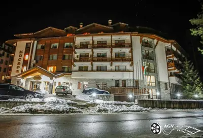 a large building with cars parked in front of it at Ski In Out Aparthotel Kosara in Bansko