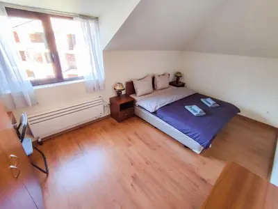 a small bedroom with a bed and a window at 