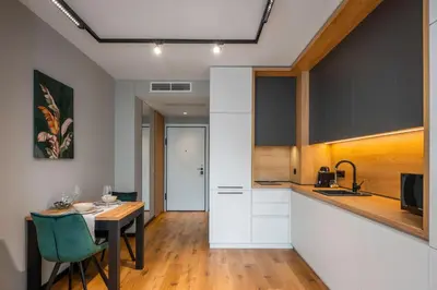 a kitchen and dining room with a table and a counter at Aviva Living by Flat Mаnager in Sofia