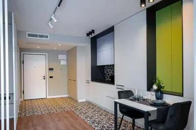 a living room with a table and a green wall at Aviva Living by Flat Mаnager in Sofia