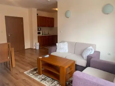 a living room with a couch and a table at Cozy Mountain Apartment in Bansko