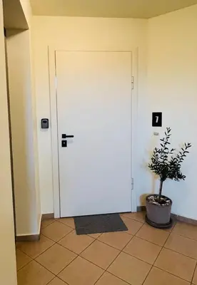 a door in a room with a potted plant at FREESIA apartment with underground parking in Sofia