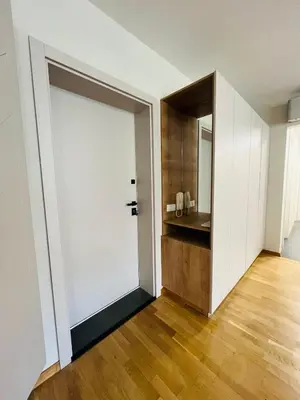 a large white door in a room with a bathroom at FREESIA apartment with underground parking in Sofia