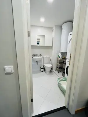 a bathroom with a toilet and a sink at FREESIA apartment with underground parking in Sofia