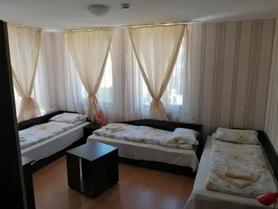 a room with two beds and a window at Guest House Tsenovi in Koprivshtitsa